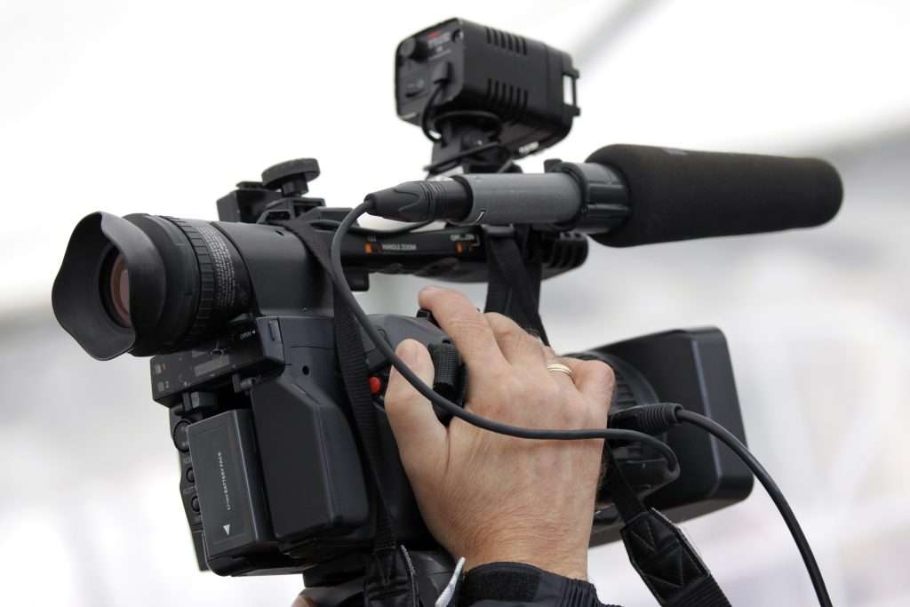 hand of the cameraman holding video camera 2022 12 01 22 47 07 utc