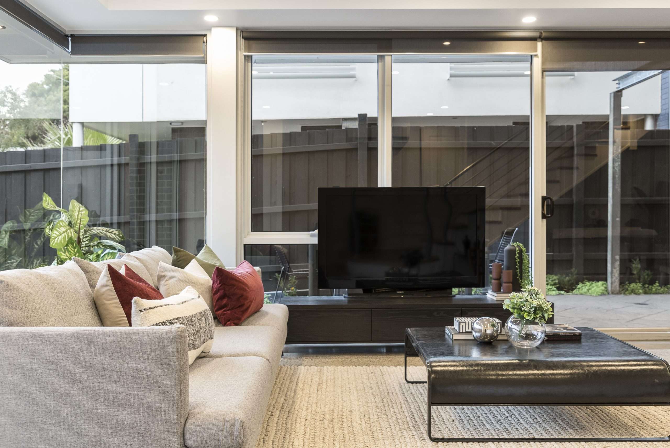 A modern living room with glass sliding doors.